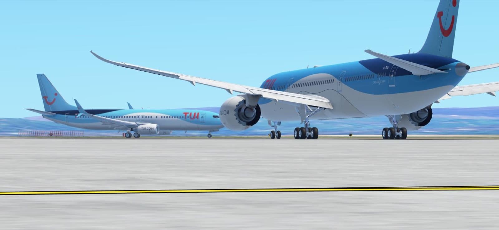 A TUI Boeing 787 and Boeing 737 together on the runway