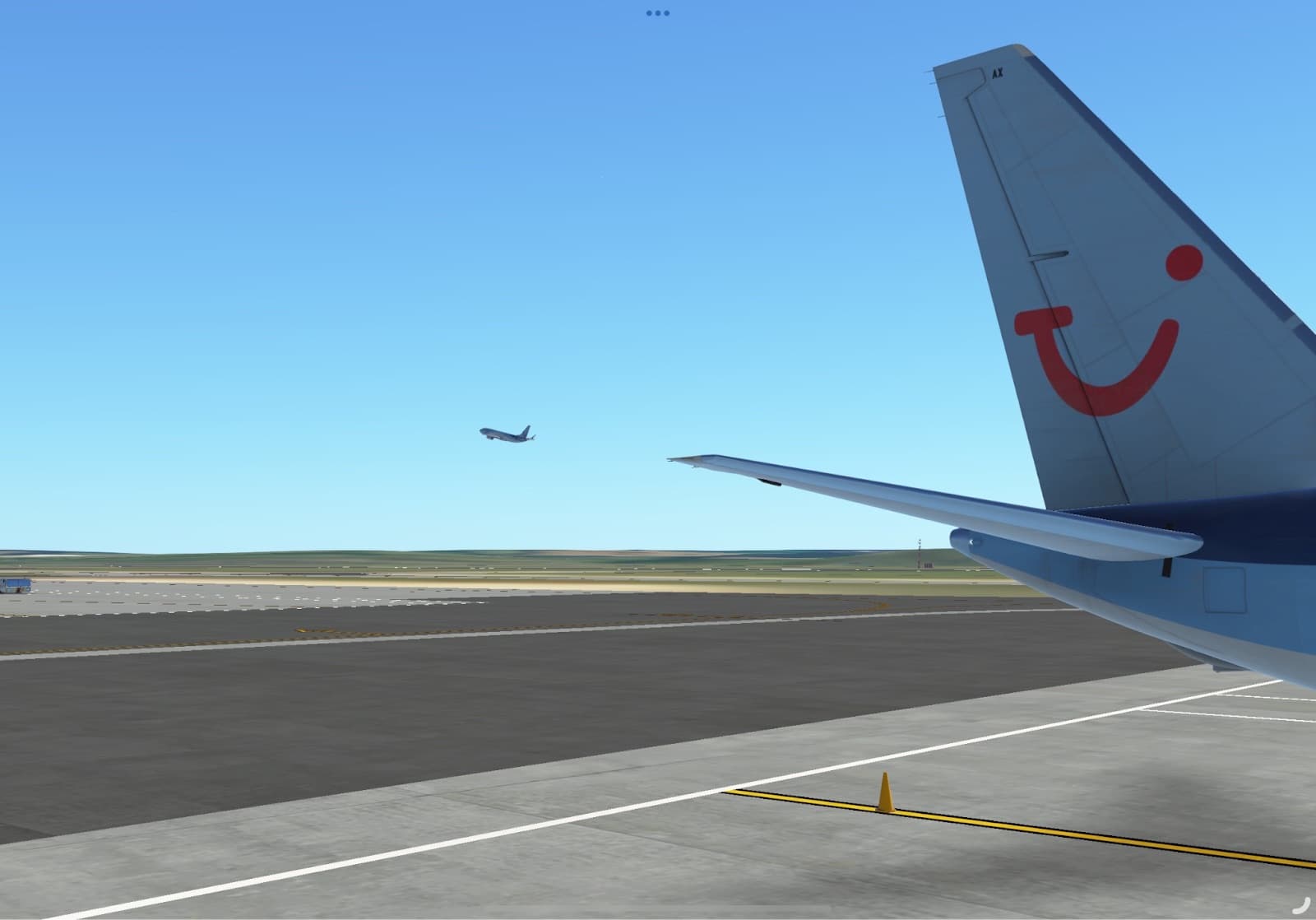 A TUI tail with its red smile as another aircraft climbs away in the distance