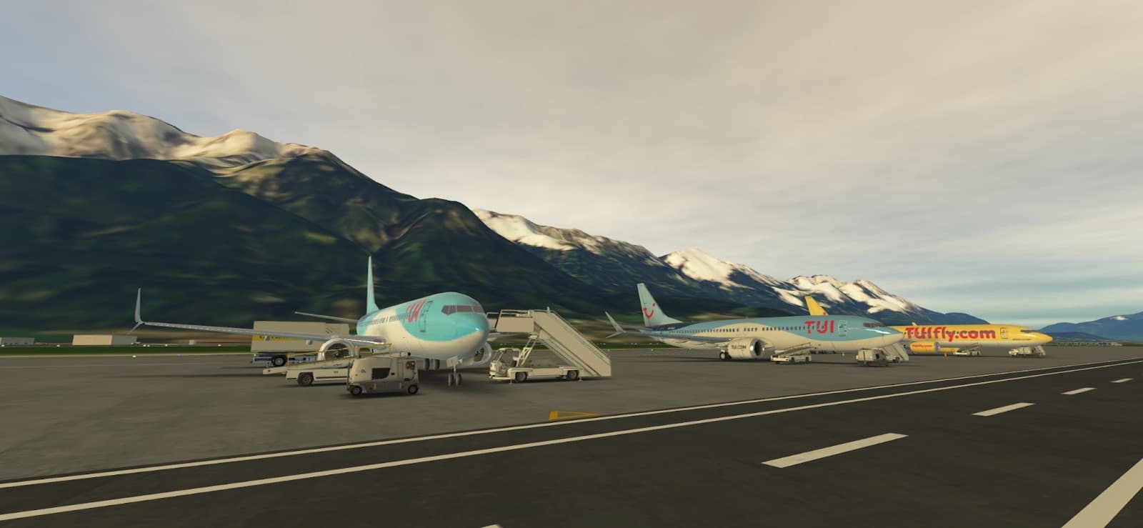 TUI and TUIfly aircraft parked at an alpine airport surrounded by mountains